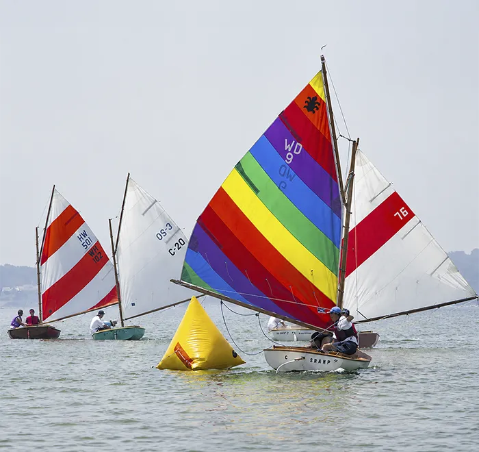 Colorful Beetle Cats rounding yellow racing buoy